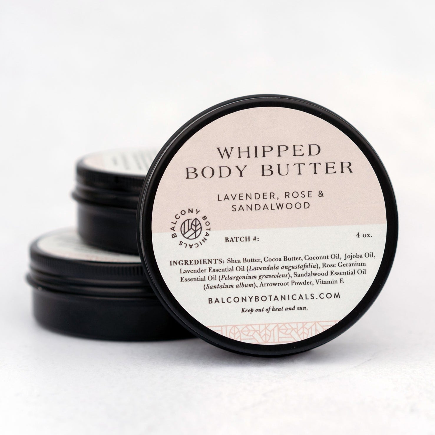 Lavender, Rose and Sandalwood whipped body butter in stacked in black tins.