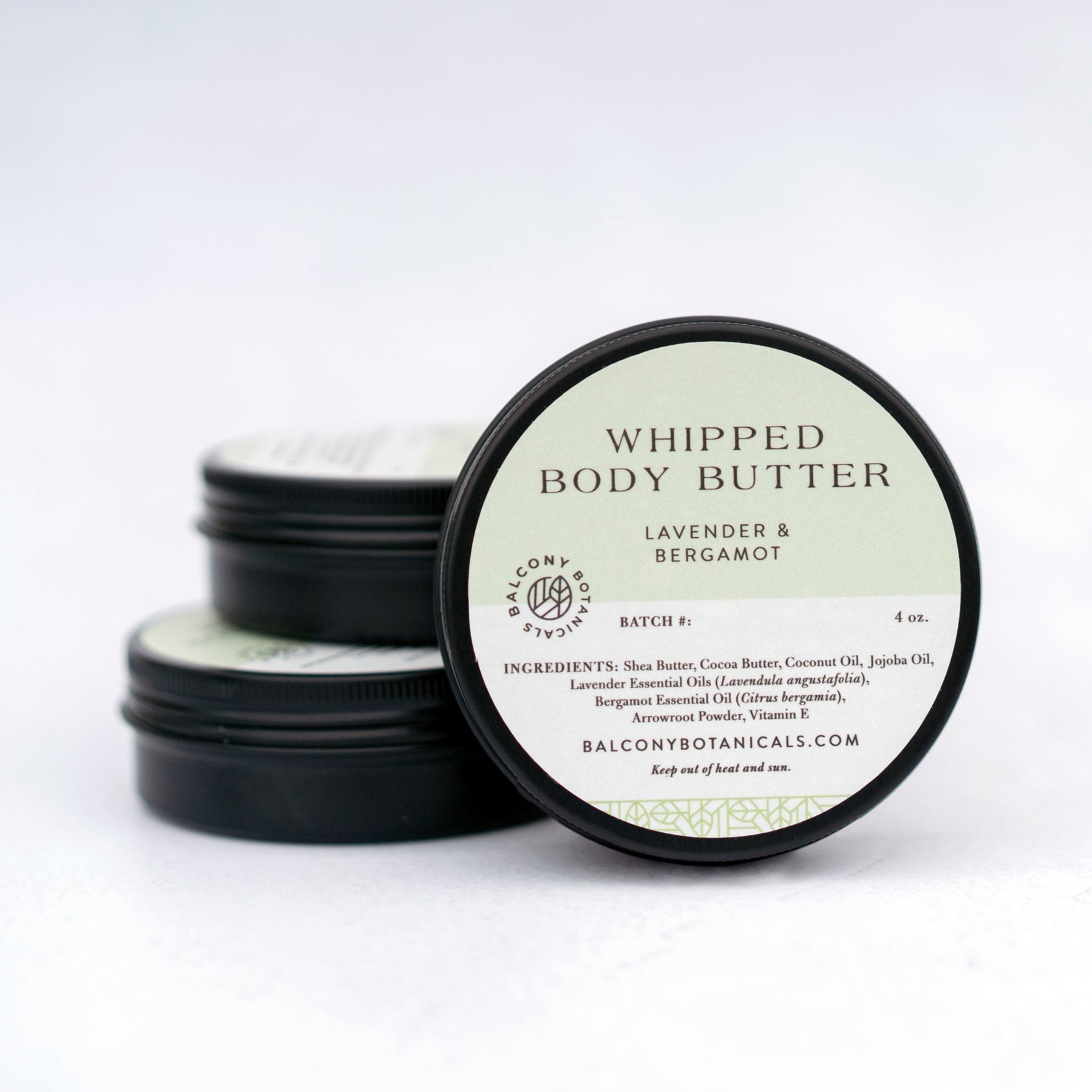 Lavender & Bergamot Whipped Body Butter in three black tins.