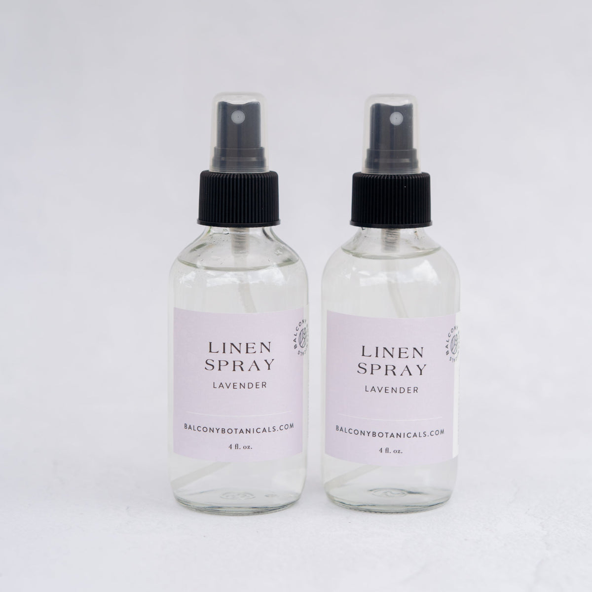 Two glass bottles of Lavender Hydrosol Linen Spray. 